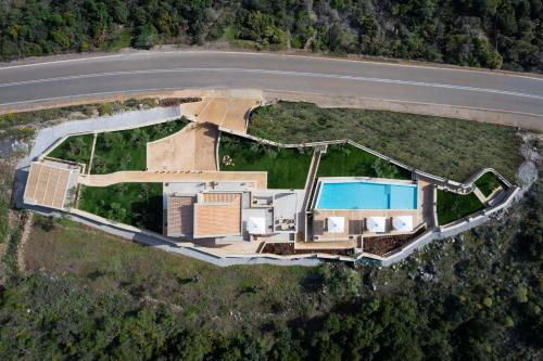 an aerial view of a house with a swimming pool at Foneas Bay Villa in Proástion