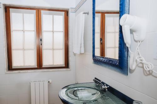 a bathroom with a sink and a mirror at Casa Veiga in Valdoviño