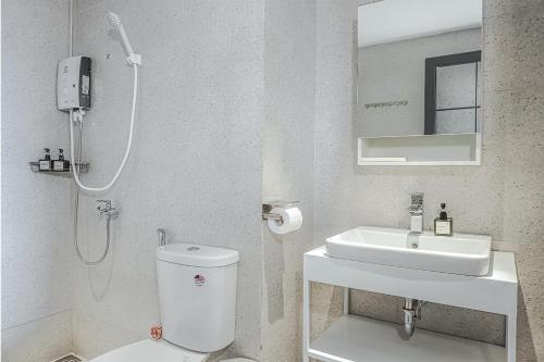 a bathroom with a shower and a toilet and a sink at M Village Living Nguyễn Văn Hưởng in Ho Chi Minh City