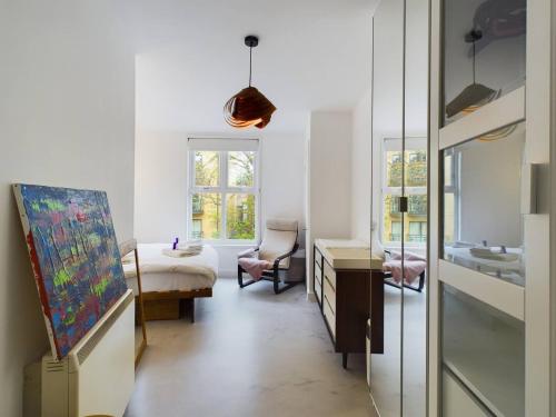a living room with a painting on the wall and a chair at Pass the Keys Stylish and Modern 2Bed 2Bath Hackney Apartment in London