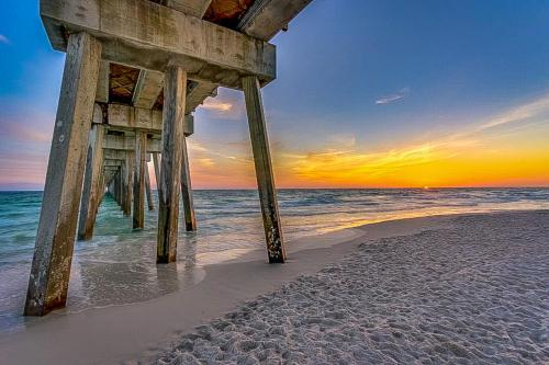 a pier on the beach with the ocean at Lake Town Wharf in Panama City Beach