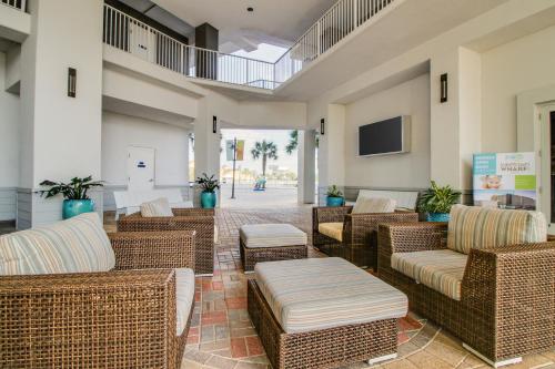 a lobby with wicker furniture and a flat screen tv at Lake Town Wharf in Panama City Beach