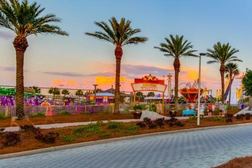 a park with palm trees and a roller coaster at Lake Town Wharf in Panama City Beach