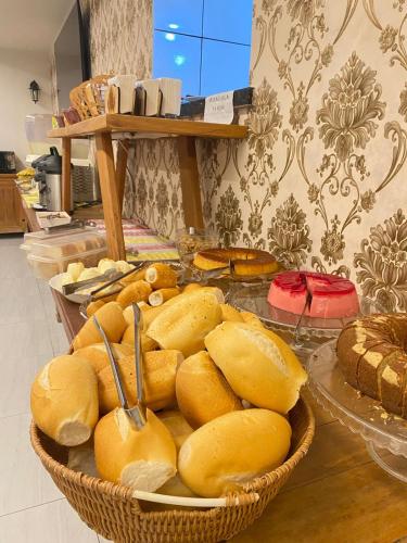 a basket of bread on a table in a kitchen at Hotel Central Campo Grande in Campo Grande