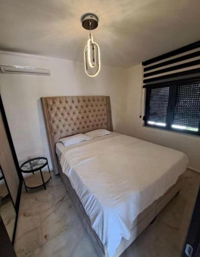 a bedroom with a large bed in a room at Jerfihouse in Budva