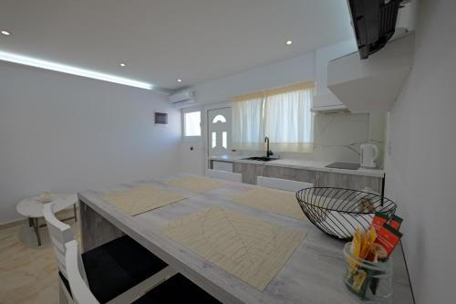 a kitchen with a table and a counter top at Livia's Guesthouse in Ksamil