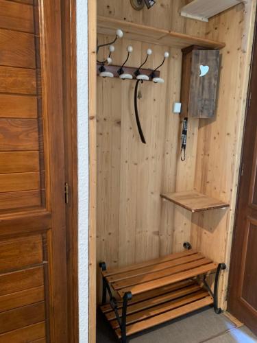a wooden sauna with a bench in a room at 2 pièces La Clusaz Centre village dans petite résidence in La Clusaz