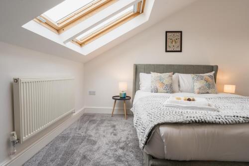 a bedroom with a bed and a skylight at Beautifully done 5 bed barn conversion in Heswall - Sleeps up to 10 in Heswall