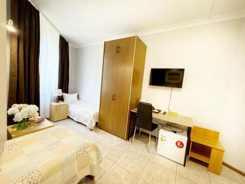 a hotel room with a bedroom with a desk and a bed at SIGNEEV'S Villa in Kyiv