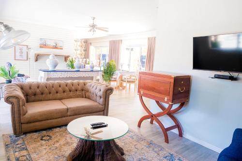 a living room with a couch and a flat screen tv at 36 Alexander Guesthouse,Highlands,Harare in Highlands