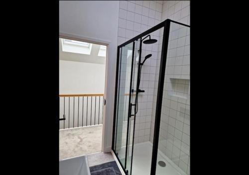 a shower with a glass door in a bathroom at 3 bed House in Newquay, Cornwall in Newquay