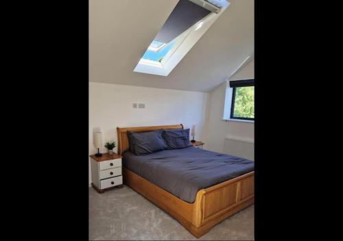 a bedroom with a bed and a skylight at 3 bed House in Newquay, Cornwall in Newquay