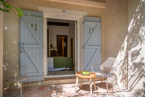 a door leading into a bedroom with a table and chairs at Lou Cagnard in Saint-Tropez