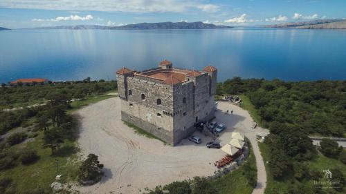 an aerial view of a castle in the middle of a lake at Apartment Ana in Senj