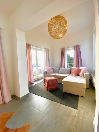 a living room with a couch and some windows at Einzigartiges Haus mit wunderbaren Seeblick auf Lago Maggiore in Massino Visconti