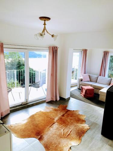 a living room with a large rug on the floor at Einzigartiges Haus mit wunderbaren Seeblick auf Lago Maggiore in Massino Visconti