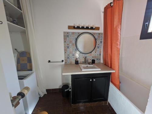 une salle de bain avec un lavabo et un miroir dans l'établissement Maison Brissac, à Brissac