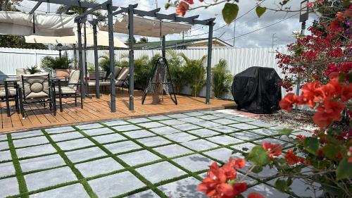 a patio with a pergola and a table and chairs at Dream House 4B/2B King Bed Miami Springs, FL in Miami