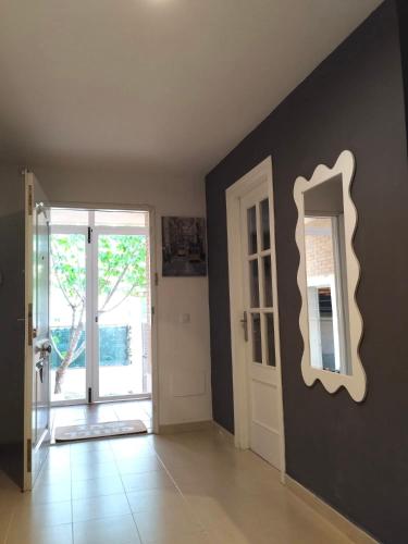 a room with a mirror on the wall and a door at Chalet con JARDIN PUY DU FOU a 10 min ,NO FIESTAS!! in Toledo