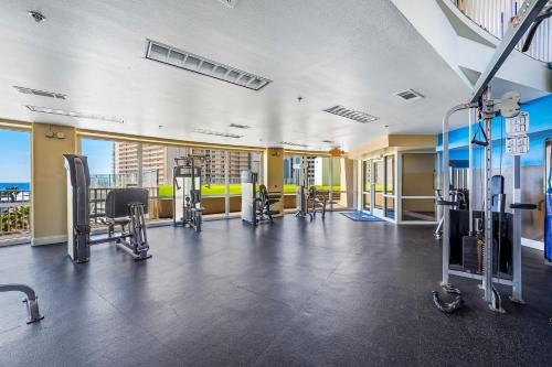 a gym with cardio equipment in a building at Lake Town Wharf in Panama City Beach