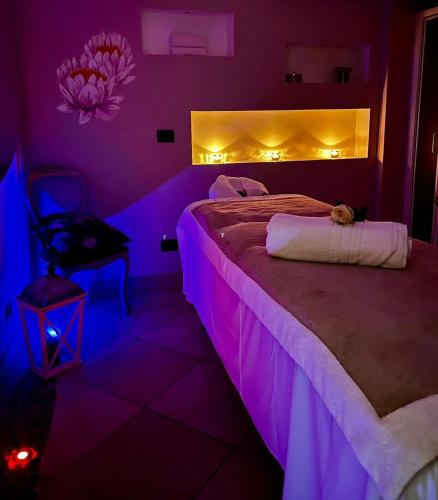a bedroom with a bed with purple lights on it at Hotel Regina in Alassio