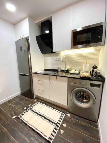 cocina con nevera y lavadora en Gilber apartment sleep 3 en Londres