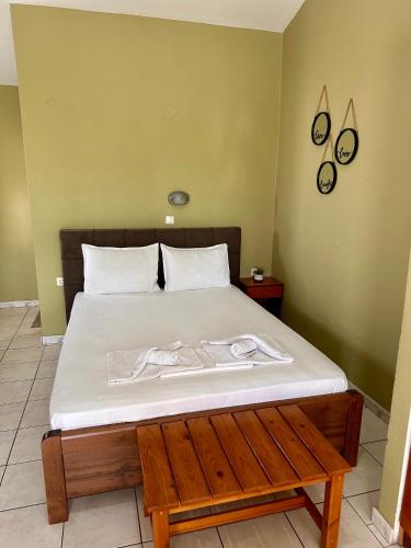 a bedroom with a bed with two towels on it at Artemis Hotel Apartments in Keramoti