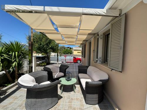 a patio with couches and chairs and a table at Marigoulis Home in Sami