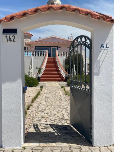 a gate leading to a house with a staircase at California Dream Inn in Aljezur