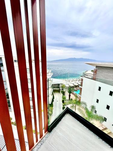 a view of the ocean from the balcony of a building at Andon Lapa Hotel & Spa in Sarandë