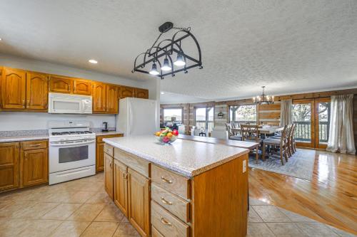 a kitchen with wooden cabinets and white appliances and a table at Panoramic Mtn Views Spacious Tennessee Home! in Newport