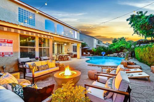 an outdoor patio with a fire pit and a pool at Enchanting Clovis Haven with Hot Tub and Private Pool! in Clovis