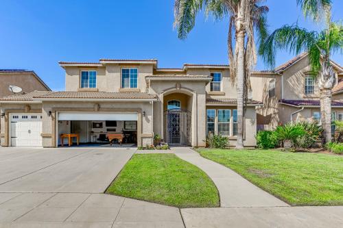 a house with palm trees and a driveway at Enchanting Clovis Haven with Hot Tub and Private Pool! in Clovis