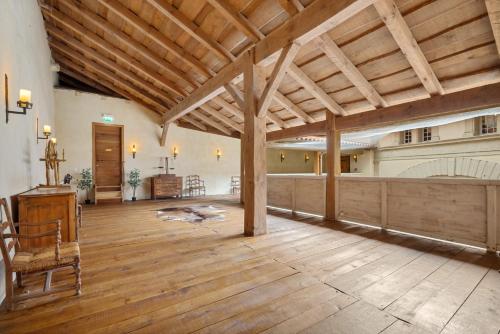 a large living room with a wooden ceiling and wooden floors at Château de Saint Vidal in Le Puy en Velay