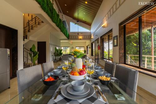a dining room with a table with food on it at Ekostay Kingfisher Villa I Indoor Pool I Cloud 9 in Lonavala