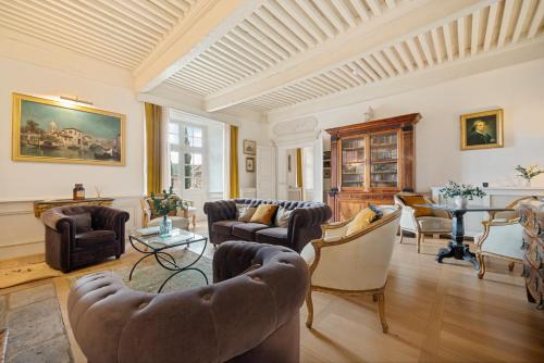 a living room with couches and chairs and a table at Château de Saint Vidal in Le Puy en Velay