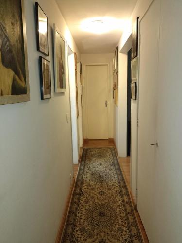a hallway with a rug on the floor at Apartamento Parque Jardim Europa in Rio de Janeiro