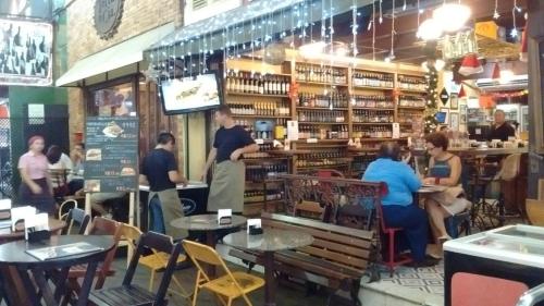 a restaurant with people sitting at tables in a store at Apartamento Parque Jardim Europa in Rio de Janeiro