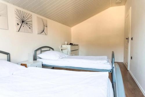 two beds in a room with white sheets at Ferienhaus Steinhoff in Marsberg