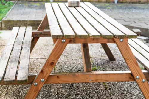 a wooden picnic table sitting next to a bench at Ferienhaus Steinhoff in Marsberg