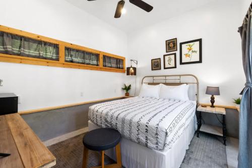 a bedroom with a bed and a desk and a window at Cape Keepers Cottage - Lighthouse Park in Saint Augustine
