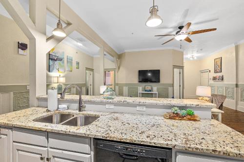 a kitchen with a sink and a living room at The Ray- 1st Floor Charming Condo- Walk to Downtown in Saint Augustine