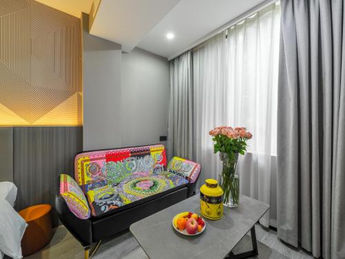 a living room with a couch and a table at Orient Rose International Hotel in Shanghai