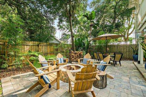 a patio with chairs and a table and an umbrella at Casa DeSoto - Luxury Downtown Oasis in St. Augustine