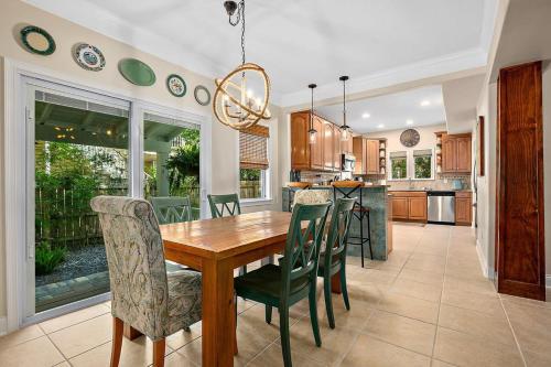 a kitchen and dining room with a wooden table and chairs at Casa DeSoto - Luxury Downtown Oasis in St. Augustine