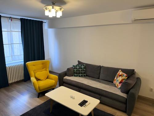 a living room with a couch and a chair at Central Park Apartments in Belgrade