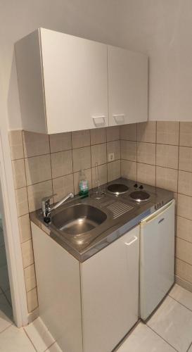 a kitchen with a sink and a counter at KANALI HOLIDAYS APARTMENT 1 in Kanali