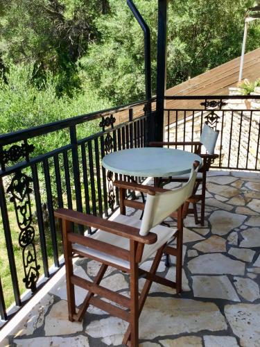 a table and two chairs on a balcony at Rena Studios in Paleokastritsa