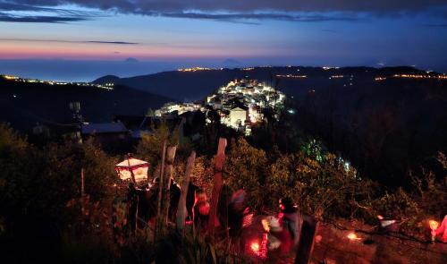 a group of people standing on a hill at night at Borgo Maria Rosa in San Salvatore di Fitalia