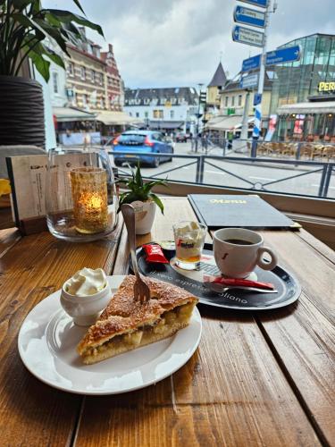 a table with a plate of toast and a cup of coffee at Hotel 1711 in Valkenburg